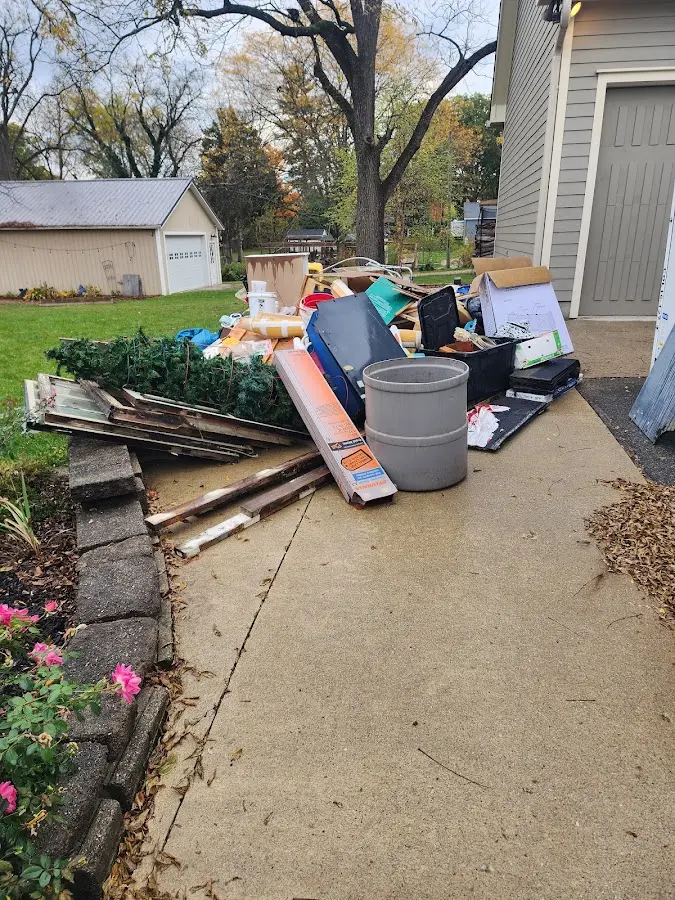 Dumpster being loaded with debris for 12 Yard Dumpster Rental in June Park